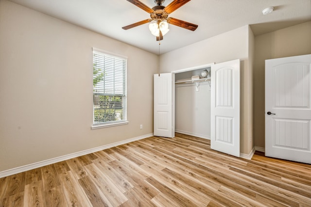 unfurnished bedroom featuring light hardwood / wood-style floors, ceiling fan, and a closet