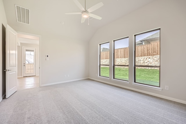 carpeted empty room with vaulted ceiling and ceiling fan