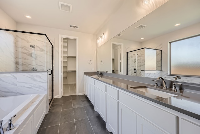 bathroom with vanity, independent shower and bath, and tile patterned flooring