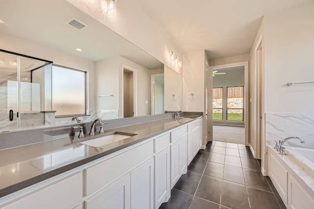 bathroom featuring vanity, tile patterned floors, and plus walk in shower