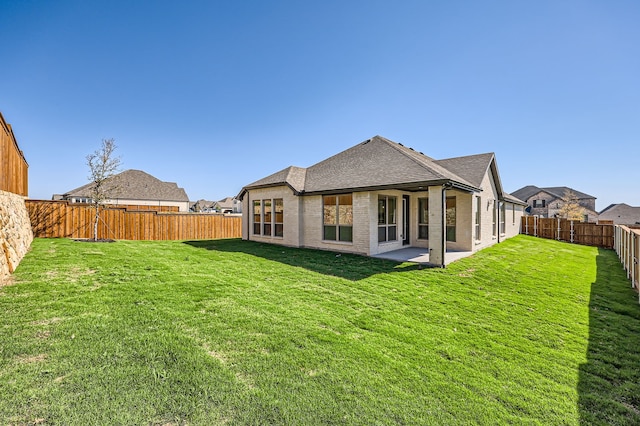 back of property with a patio and a lawn