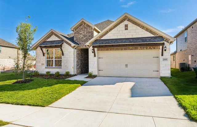 view of front of property with a garage and a yard