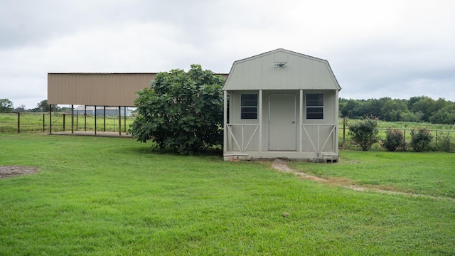 view of shed featuring a rural view and fence