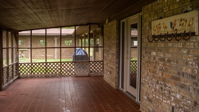 unfurnished sunroom with plenty of natural light and wood ceiling