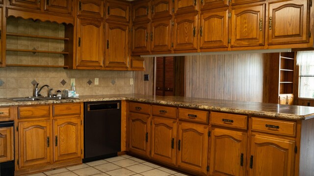 kitchen with kitchen peninsula, tasteful backsplash, sink, black dishwasher, and light tile patterned flooring