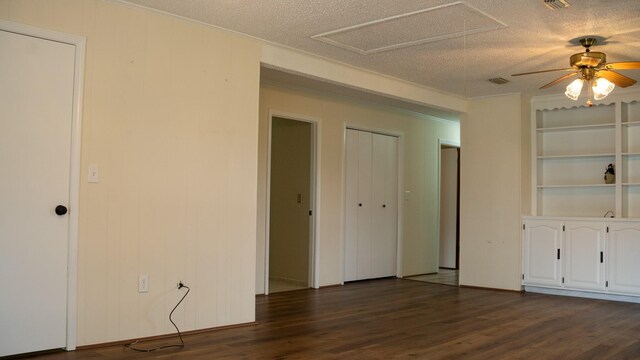 interior space with ceiling fan, wood-type flooring, and a textured ceiling