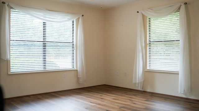 unfurnished room with hardwood / wood-style floors