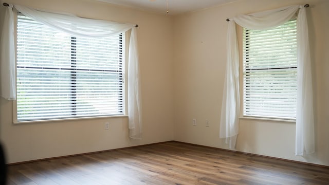 spare room featuring wood finished floors