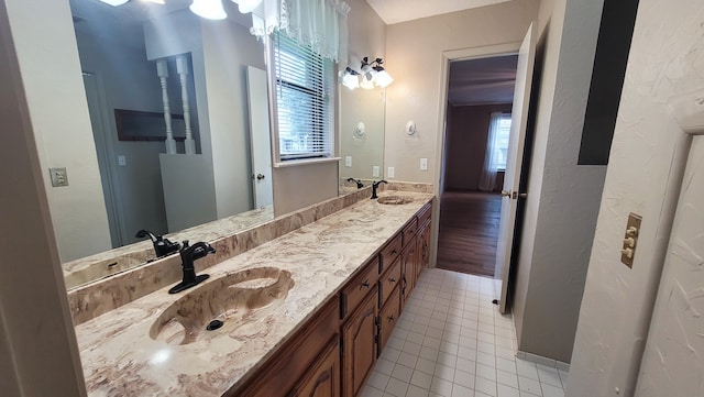 bathroom with tile patterned flooring and vanity