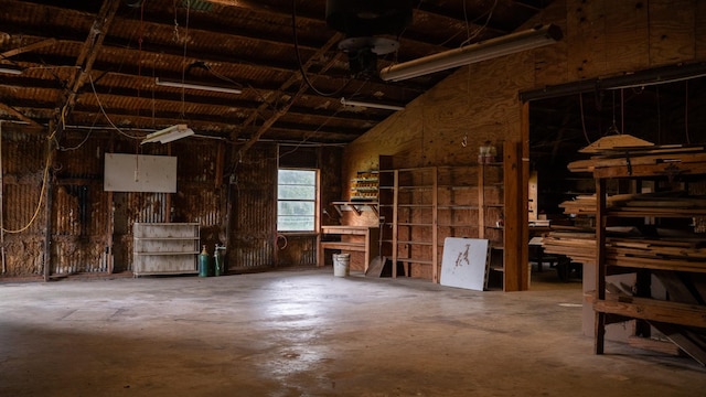 miscellaneous room featuring concrete flooring and lofted ceiling