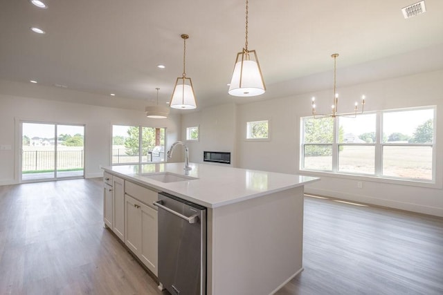 115 Palisades Dr, Gordonville, TX 76245 - kitchen featuring dishwasher, sink, white cabinets, hanging light fixtures, and a center island with sink
