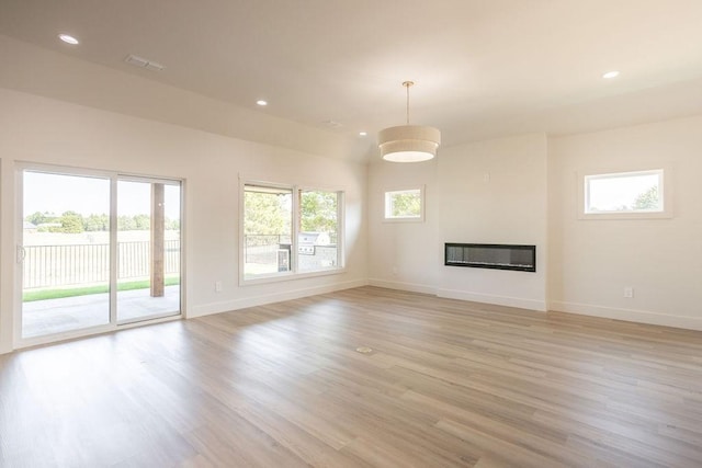 115 Palisades Dr, Gordonville, TX 76245 - unfurnished living room featuring plenty of natural light and light hardwood / wood-style flooring