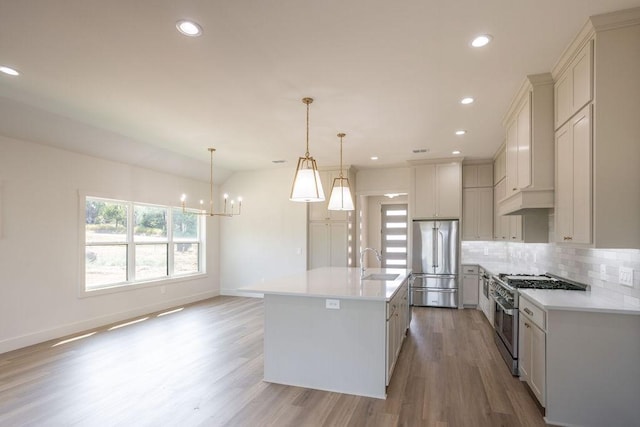 115 Palisades Dr, Gordonville, TX 76245 - kitchen featuring hanging light fixtures, sink, a kitchen island with sink, and premium appliances