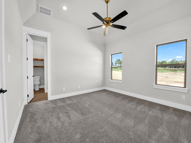 unfurnished bedroom with visible vents, baseboards, and dark colored carpet