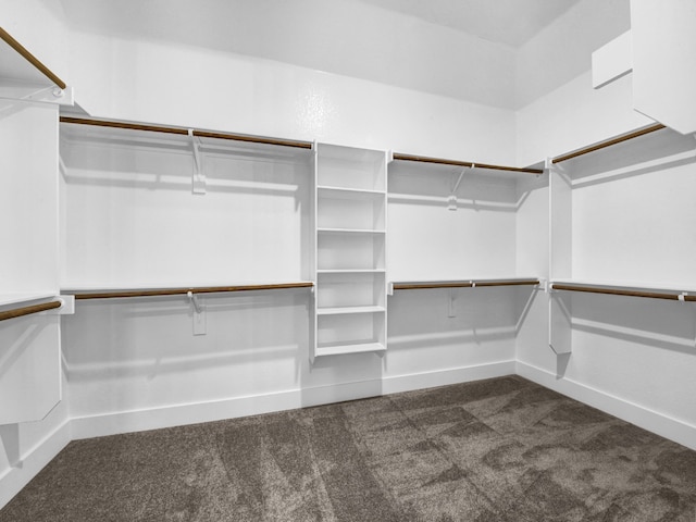 spacious closet featuring dark carpet