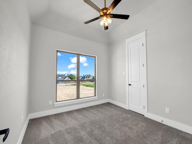 carpeted empty room with a ceiling fan and baseboards