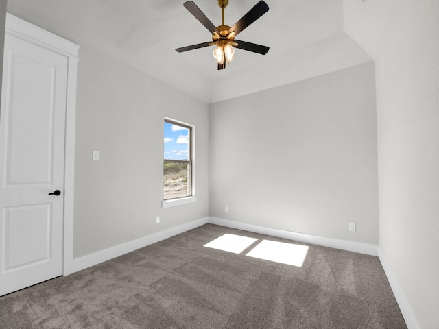 carpeted spare room featuring a ceiling fan and baseboards