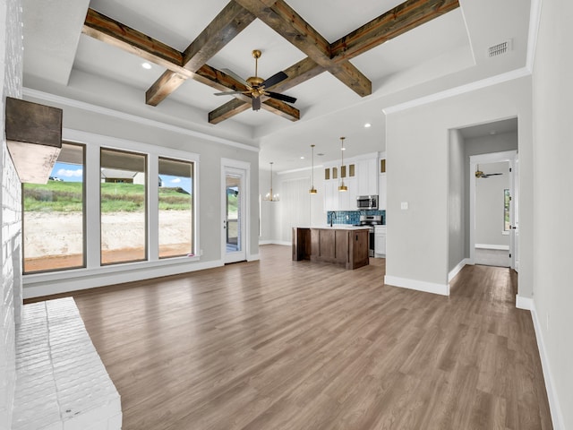 unfurnished living room with light wood finished floors, visible vents, baseboards, ceiling fan with notable chandelier, and coffered ceiling