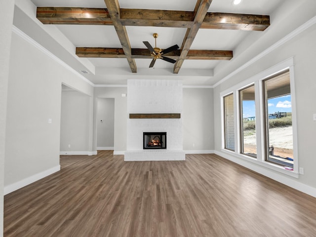 unfurnished living room featuring wood finished floors, a fireplace, and baseboards