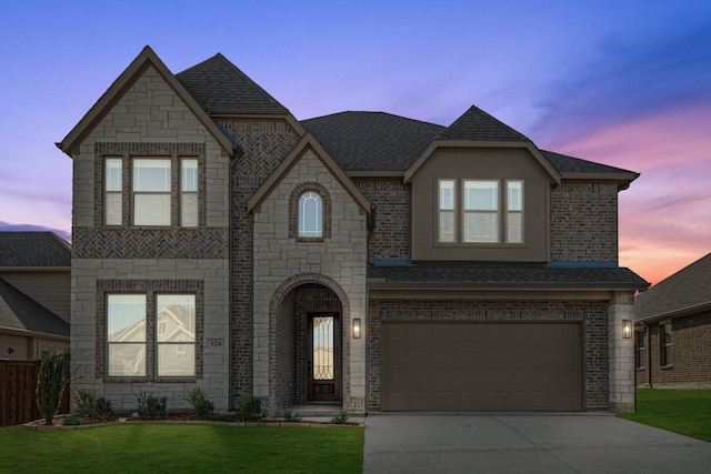 view of front of house with a yard and a garage