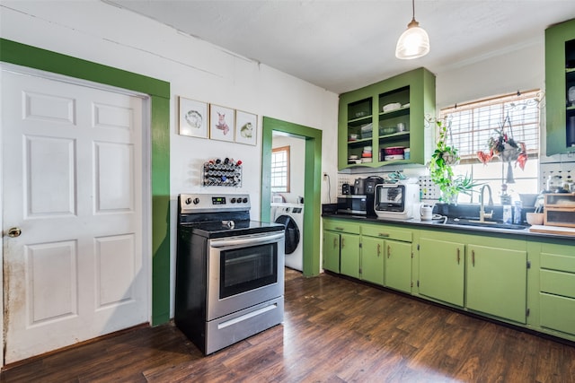 kitchen featuring washer / dryer, appliances with stainless steel finishes, sink, green cabinets, and dark wood-type flooring