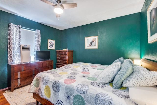 bedroom with wood-type flooring and ceiling fan