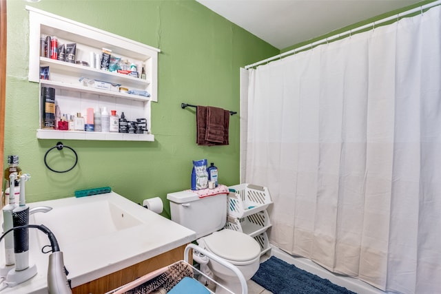 bathroom with toilet, vanity, and a shower with shower curtain