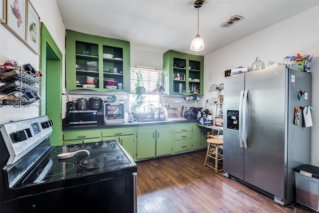 kitchen with dark wood-type flooring, stainless steel appliances, sink, and green cabinetry