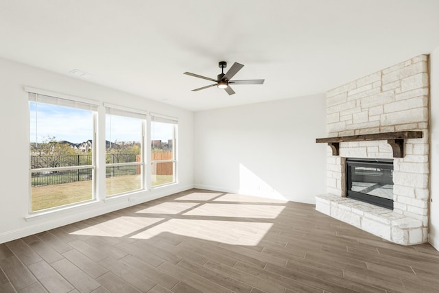 unfurnished living room with a fireplace, ceiling fan, and hardwood / wood-style floors