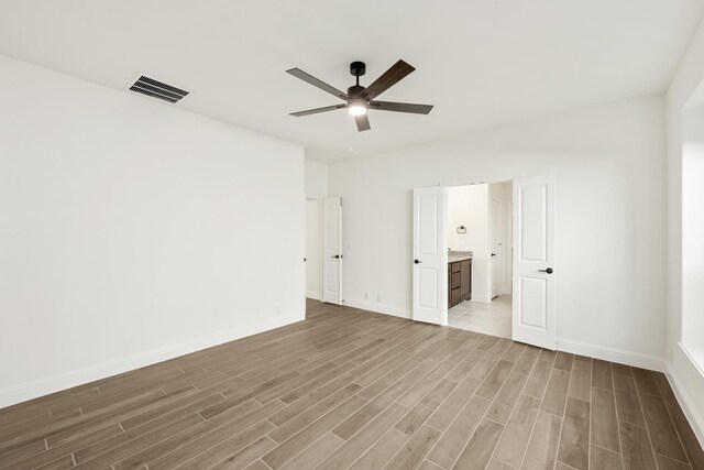 empty room with ceiling fan and wood-type flooring