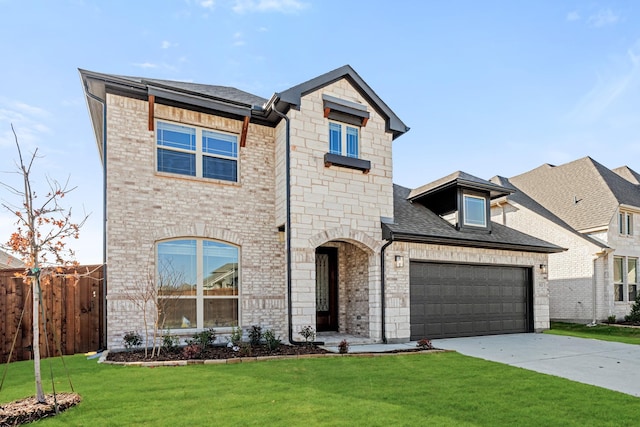 view of front of house featuring a garage and a front lawn