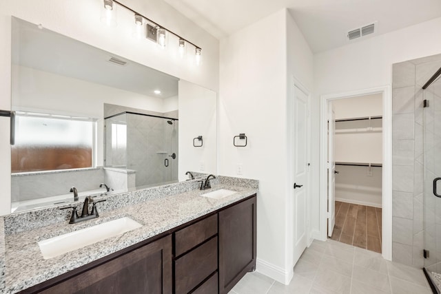 bathroom featuring vanity and an enclosed shower