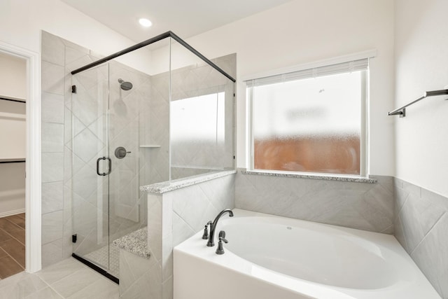 bathroom featuring separate shower and tub