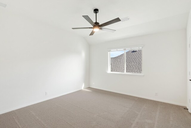 unfurnished room with carpet flooring, vaulted ceiling, and ceiling fan