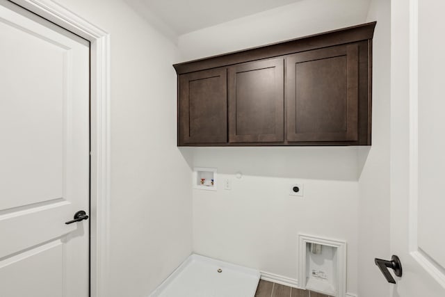 laundry room featuring cabinets, washer hookup, electric dryer hookup, hardwood / wood-style floors, and hookup for a gas dryer