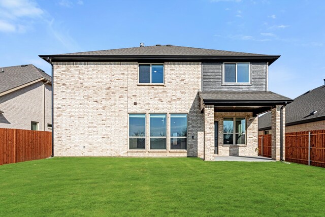 back of property with a patio and a lawn