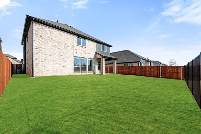 rear view of property with a lawn