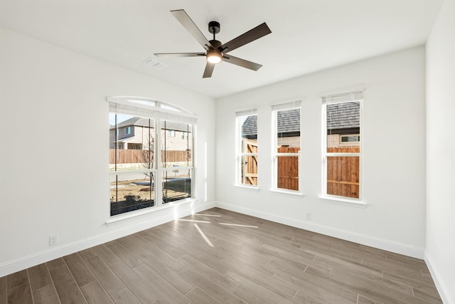 spare room featuring hardwood / wood-style flooring and ceiling fan