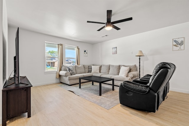 living room featuring ceiling fan and light hardwood / wood-style floors