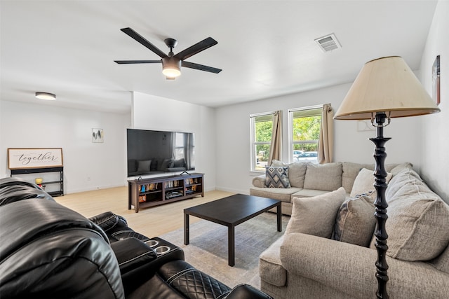 living room with ceiling fan and light wood-type flooring