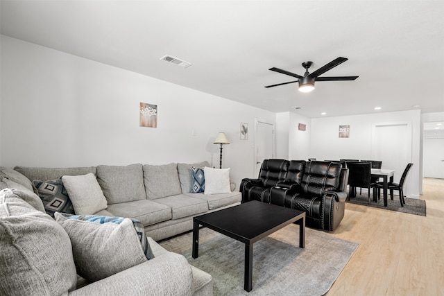 living room with ceiling fan and light hardwood / wood-style floors