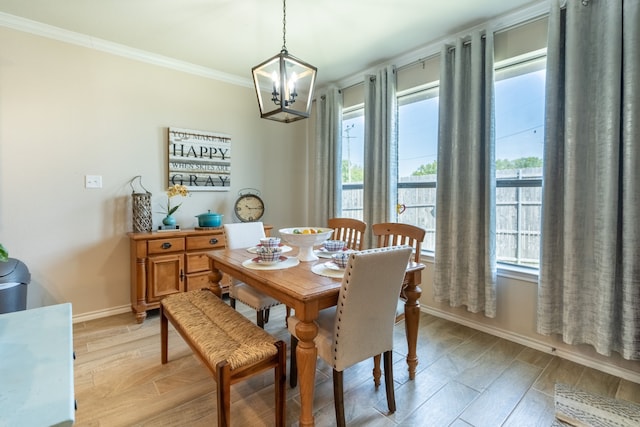 dining space with an inviting chandelier, light wood-type flooring, and crown molding