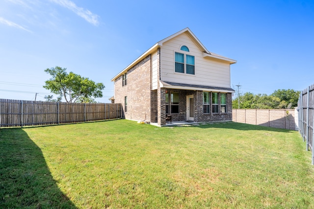 back of house with a yard and a patio area