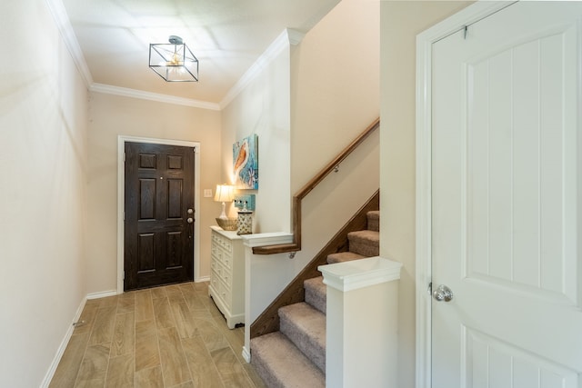 foyer entrance with light wood-type flooring and crown molding