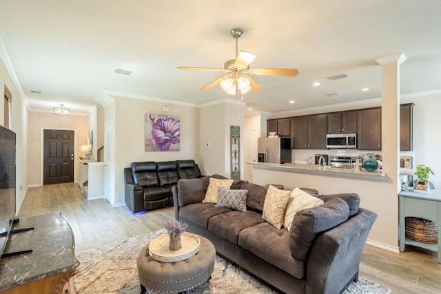 living room featuring ceiling fan, light wood-type flooring, and ornamental molding