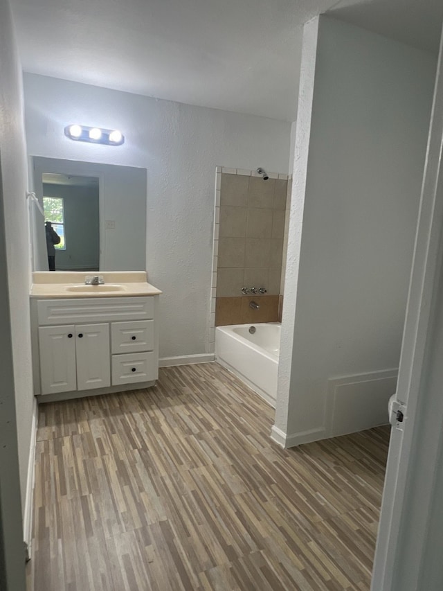 bathroom featuring wood-type flooring, vanity, and shower with separate bathtub