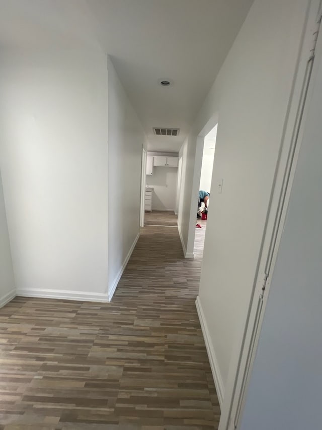 hallway with dark wood-type flooring