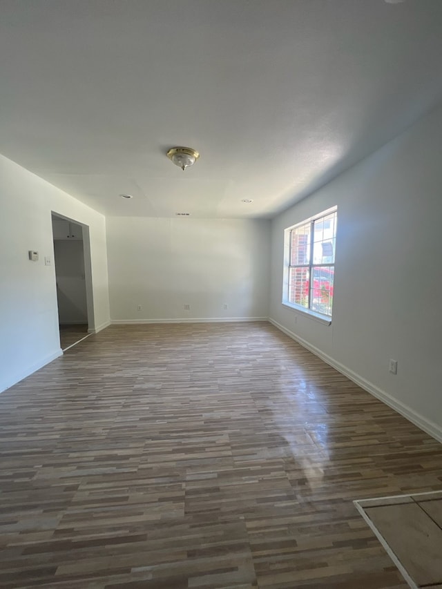 unfurnished room with dark hardwood / wood-style floors