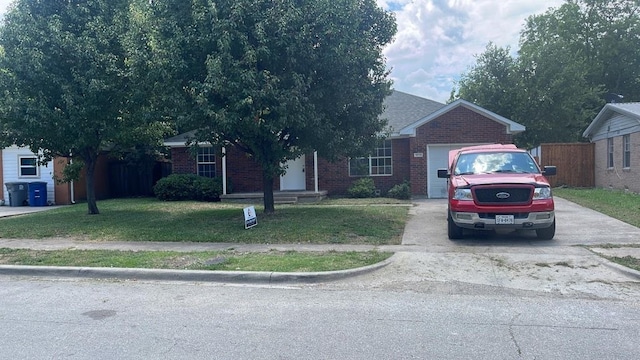 single story home featuring a garage and a front yard