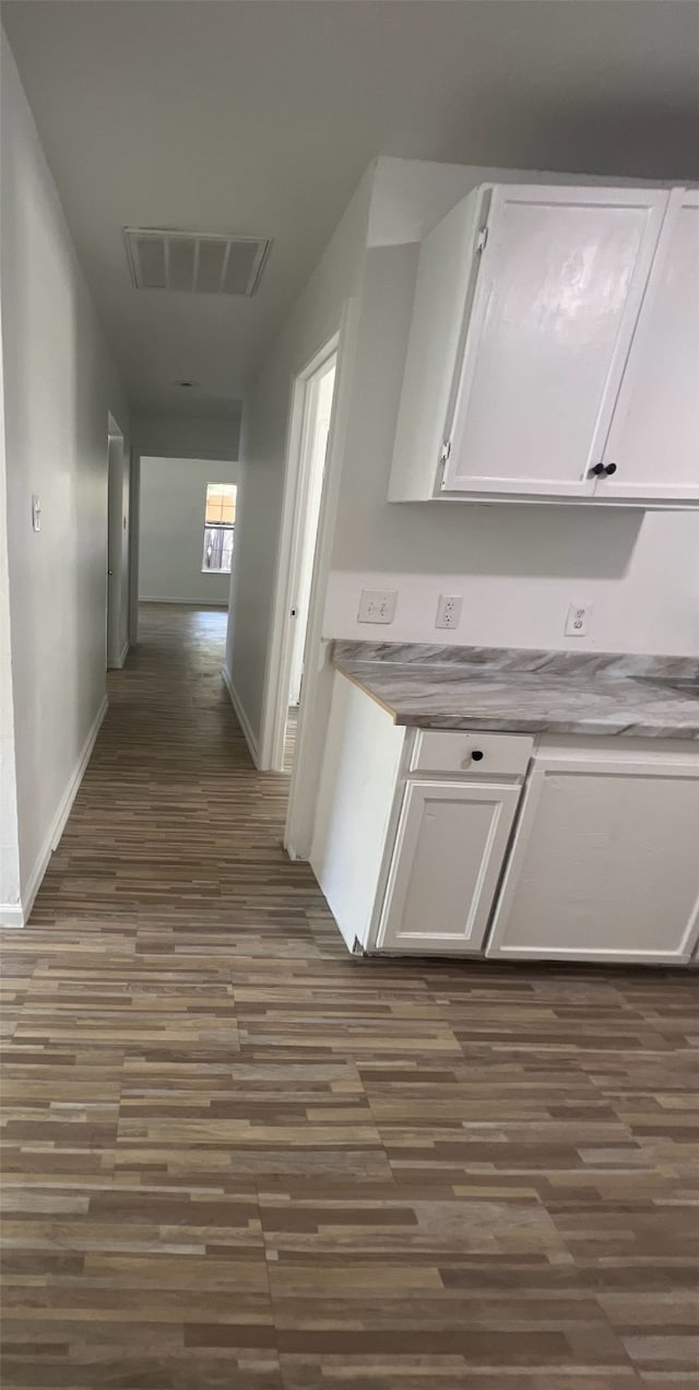 corridor featuring dark wood-type flooring